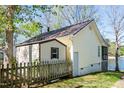Side view of a lakeside house with a fenced yard at 150 Big Horn Cv, Louisburg, NC 27549