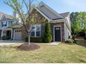 Well-kept home boasting stone details, green lawn, and welcoming front entrance at 150 Red Admiral Ct, Hillsborough, NC 27278
