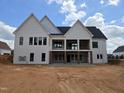 Backyard view of a modern white home with unfinished patio at 154 Bellini Dr, Clayton, NC 27527