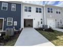 A driveway leads to a spacious garage in this modern townhome community at 1577 Wendell Valley Blvd, Wendell, NC 27591