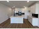 Bright kitchen features a center island, ample cabinets, and recessed lighting at 1577 Wendell Valley Blvd, Wendell, NC 27591