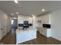 Modern kitchen boasts white cabinets, stainless appliances, and a center island at 1577 Wendell Valley Blvd, Wendell, NC 27591