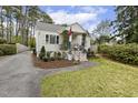 A quaint home with charming curb appeal, manicured landscaping, and a neatly paved driveway at 2008 Reaves Dr, Raleigh, NC 27608