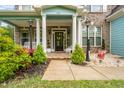 Inviting front porch with charming decor and curb appeal at 201 Blue Heron Dr, Youngsville, NC 27596