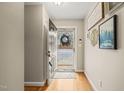 Inviting entryway with hardwood floors, neutral walls, and views of the front door with a decorative wreath at 2102 Trailridge Ct, Raleigh, NC 27603
