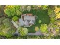 A well-manicured lawn surrounds this home, nestled between mature hardwood trees at 2204 Secluded Oaks Ct, Wake Forest, NC 27587