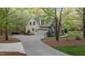 Long driveway leads to a spacious two-car garage and a well-maintained, landscaped yard at 2204 Secluded Oaks Ct, Wake Forest, NC 27587