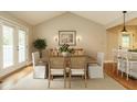 Dining room features neutral tones, vaulted ceilings, and access to the screened porch at 2916 Rue Sans Famille, Raleigh, NC 27607