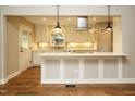 Bright kitchen with stainless hood vent, bar seating, hardwood floors, and recessed lighting at 2916 Rue Sans Famille, Raleigh, NC 27607
