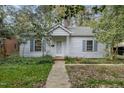 Charming single-story home with a well-maintained lawn and classic architectural details at 312 Greenwood Dr, Durham, NC 27704