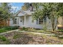 Charming single-story home with a well-maintained lawn and classic architectural details at 312 Greenwood Dr, Durham, NC 27704