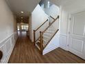 Bright foyer features wood floors, a staircase with white railings and paneled walls at 316 Catheys Creek Cir, Wendell, NC 27591