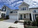 Inviting two-story home with a cozy front porch, well-maintained landscaping and attached garage at 316 Catheys Creek Cir, Wendell, NC 27591