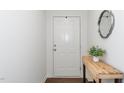 Bright entryway with hardwood floors, rustic table and neutral paint at 317 City Center Ln, Wendell, NC 27591