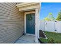 Inviting front door featuring a wreath, white trim, and house number at 317 City Center Ln, Wendell, NC 27591