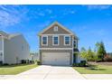 Charming home with a two-car garage, manicured lawn and beautiful curb appeal at 317 City Center Ln, Wendell, NC 27591