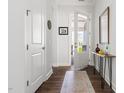 Bright entryway with hardwood floors, white walls, an open door and stylish decor at 330 Middleton Pl, Chapel Hill, NC 27516