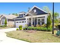 Charming home features a manicured lawn, two-car garage, covered entry, and beautifully landscaped front yard at 330 Middleton Pl, Chapel Hill, NC 27516