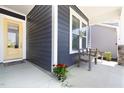 Inviting front porch with a yellow door, decorative plants, and seating area at 330 Middleton Pl, Chapel Hill, NC 27516