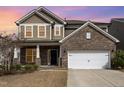 Charming two-story home with a brick and siding exterior, featuring a two-car garage and well-maintained landscaping at 3360 Bordwell Ridge Dr, New Hill, NC 27562