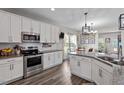 Modern kitchen features white cabinets, stainless steel appliances, and a center island at 34 Tea Olive Ct, Clayton, NC 27520