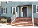 Close up of the front entrance, showing brick steps and a covered porch at 3418 Carriage Trl, Hillsborough, NC 27278