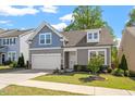 Charming two-story home featuring a two-car garage, manicured lawn, and tasteful landscaping at 356 Avery Glenn Way, Fuquay Varina, NC 27526