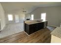 Open-concept kitchen with granite counters, stainless sink, and bar overlooking the living area at 37 Heatherglenn Cir, Princeton, NC 27569