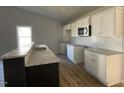 Modern kitchen featuring white cabinets, granite countertops, and stainless steel appliances at 37 Heatherglenn Cir, Princeton, NC 27569