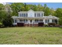 Inviting two-story home with a covered front porch, black shutters, and well-manicured landscaping at 3787 Pleasant Hill Church, Siler City, NC 27344