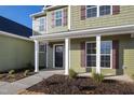 Inviting home entrance with a covered porch, white columns, and fresh landscaping details at 40 Rosewood Ln, Youngsville, NC 27596
