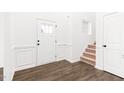 Bright foyer with hardwood floors, a staircase, and paneled walls at 40 Rosewood Ln, Youngsville, NC 27596