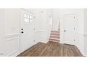 Bright foyer with hardwood floors, staircase and paneled walls at 40 Rosewood Ln, Youngsville, NC 27596