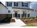 Inviting front porch with brick accents and white columns at 40 Rosewood Ln, Youngsville, NC 27596