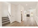 Open concept living space with hardwood floors and a cozy fireplace at 40 Rosewood Ln, Youngsville, NC 27596