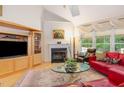 Cozy living room featuring a fireplace, large windows, and hardwood floors at 401 Stinhurst Dr, Durham, NC 27713