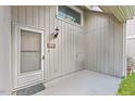 Inviting front entrance featuring a neutral door, modern light fixture, and a cozy outdoor space at 4101 Five Oaks Dr # 40, Durham, NC 27707