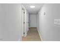Bright hallway with neutral paint, wood-look flooring and a clear view of the front door at 4101 Five Oaks Dr # 40, Durham, NC 27707