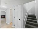 Interior view of the carpeted stairway with a view of the living room fireplace at 4101 Five Oaks Dr # 40, Durham, NC 27707