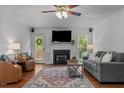 Inviting living room with a cozy fireplace, plush seating, and natural light, perfect for relaxation and entertainment at 413 Bayles Rd, Lillington, NC 27546