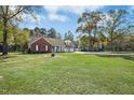 Lovely single-Gathering home with a brick facade, well-maintained lawn, and a two-car attached garage at 460 Mann Rd, Coats, NC 27521