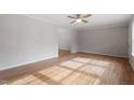 Open-concept living area featuring hardwood floors and neutral paint, offering a bright and airy feel at 4720 Brigadoon Dr, Durham, NC 27705