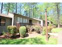 Attractive condo featuring well-maintained landscaping and a wooden porch at 502 W Poplar Ave # C2, Carrboro, NC 27510