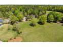 Expansive property features a lush green lawn, mature trees, and fenced-in perimeter at 5212 Theys Rd, Raleigh, NC 27606