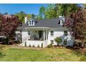 Inviting two-story home with a cozy front porch, perfect for relaxing and enjoying the outdoors at 5212 Theys Rd, Raleigh, NC 27606