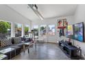 Bright living room with modern decor, large windows, and an outside view of the backyard and pool at 545 E Lenoir St, Raleigh, NC 27601