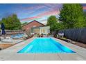 Beautiful backyard featuring a rectangular swimming pool, lounge chairs, and lush greenery at 545 E Lenoir St, Raleigh, NC 27601