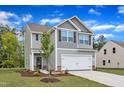 Attractive two-story home featuring a two-car garage, stylish siding, and a neatly landscaped front yard at 601 Benton Dr, Oxford, NC 27565