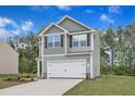 Stylish two-story home with gray siding, a two-car garage, and professionally landscaped front yard at 601 Benton Dr, Oxford, NC 27565