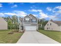 Beautiful two-story home boasts an attached two-car garage, long driveway and well-kept lawn at 601 Benton Dr, Oxford, NC 27565